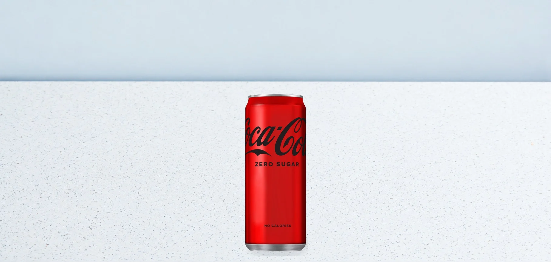 2990-coca-cola-zero-033 | Taco Bell Hrvatska Red Coca-Cola Zero Sugar can centered on a speckled white surface with a pale blue background, facing forward to show the label.